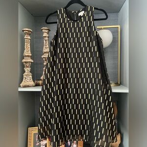 Black cocktail dress with metallic gold details